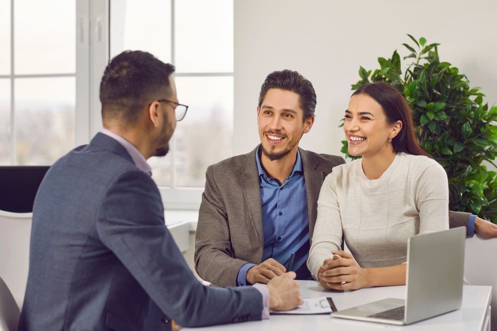 Young family couple meeting with strata manager